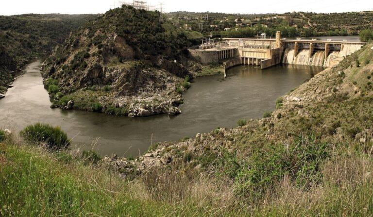 Presa del Salto de Villalcampo vista desde la ladera, con el Duero formando un meandro delante del muro y las compuertas